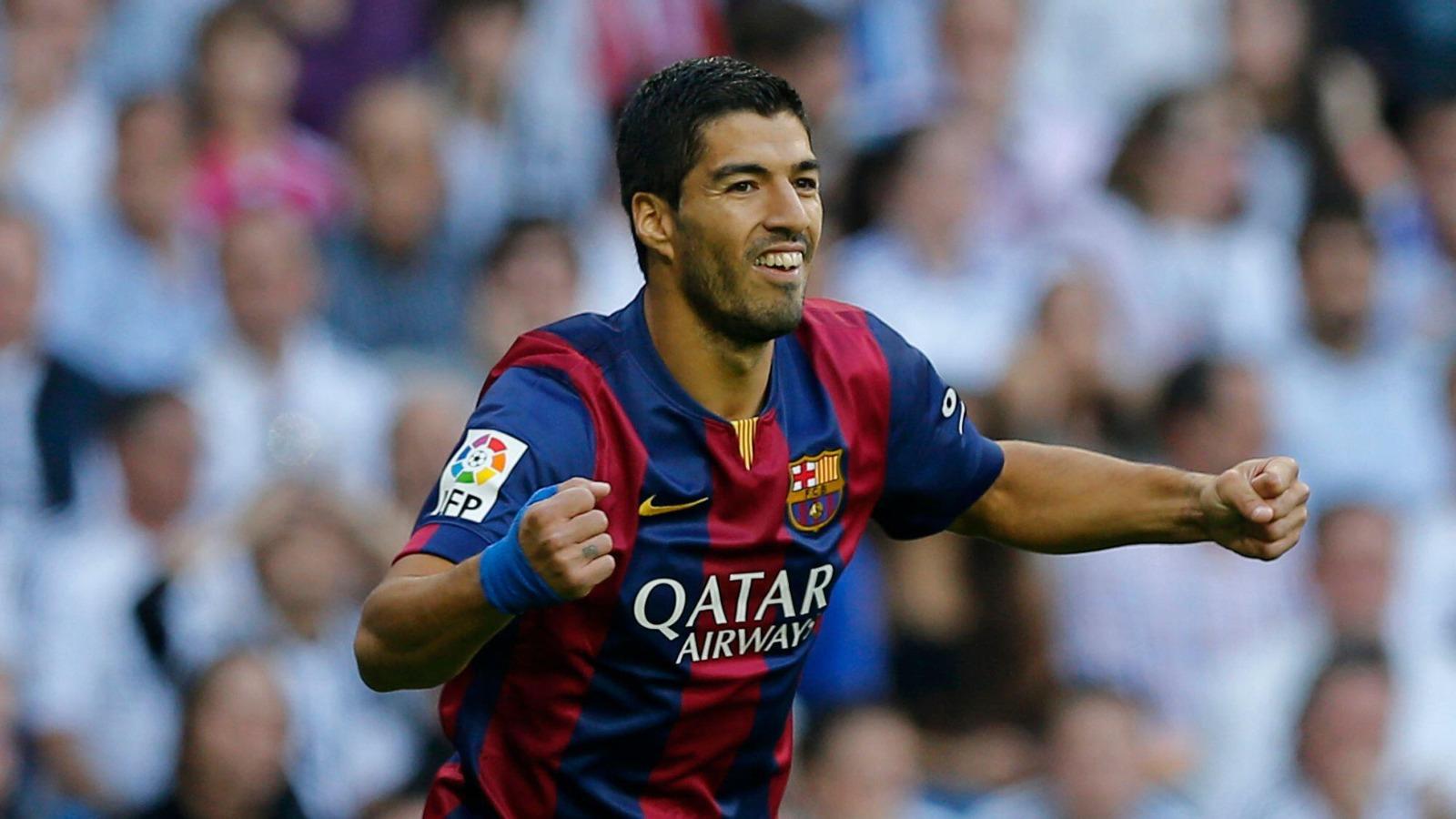 Barcelona's Luis Suarez celebrates after Barcelona teammate Neymar scored during a Spanish La Liga soccer match between Real Madrid and Barcelona at the Santiago Bernabeu stadium in Madrid, Spain, Saturday Oct. 25, 2014.